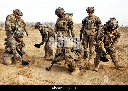 Soldiers of Bronco Troop, 1st Squadron, 14th Cavalry Regiment, 3rd Brigade, 2nd Infantry Division, level the ground during strongpoint construction, Zharay district, Kandahar province, Afghanistan, Feb. 10, 2012. Bronco Troop is helping build the strongpoint to support security in the district. Stock Photo