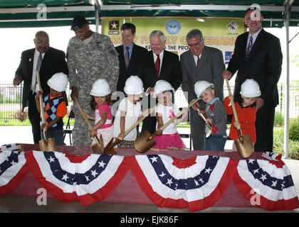 Back row from left, Geary County USD 475 Superintendent Ron Walker; Maj. Gen. Vincent Brooks, 1st Infantry Division and Fort Riley commanding general; Kansas Gov. Sam Brownback; Secretary of Defense Robert Gates; Joseph Calcara, deputy assistant secretary of the Army for Installations, Housing and Partnerships; and Brian Beauregard, program director, Picerne Military Housing; watch future kindergarteners Jaheim Flournoy, Sarai Munoz, Alyssa Thompson, Taryn Stevenson, Kyler Urban and Alex Polen break ground on a new elementary school May 19 at the Forsyth Neighborhood Center at Fort Riley. Stock Photo