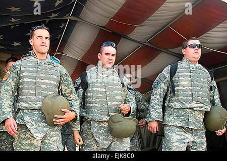 Left to right; U.S. Army Sgt. Robert Brown, Staff. Sgt., retired, Bradley Gruetzner and Sgt. Christopher A. Burrell, Soldiers wounded in combat while deployed to Iraq, walk through &quot;Hero's Highway&quot; at Air Force Theater Hospital before returning to Camp Victory after a visit to Joint Base Balad, Iraq, June 25, 2009. Brown, Gruetzner, Burrell and four other soldiers had the opportunity to return to Iraq and to visit the places they once served.  Spc. Brian A. Barbour Stock Photo