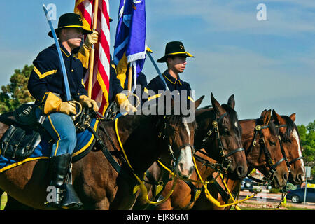 Fort Carson's mounted color guard stands alongside Soldiers from the 440th Civil Affairs Bn. at Fort Carson, Colo., Sept. 15, 2012. Stock Photo