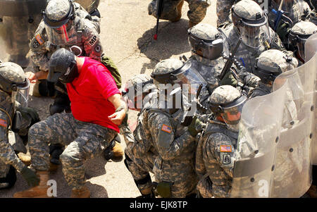 U.S. Army Soldiers of the 130th Military Police Company, Tennessee Army National Guard face down a crowd of instructors role-playing as rioters during training at the Muscatatuck Urban Training Center, Ind., Aug. 25, 2007. The Soldiers are training for an upcoming deployment to Kosovo.  Staff Sgt. Russell Lee Klika Stock Photo