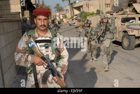 An Iraqi army soldier from 2nd Brigade, 6th Iraqi Army Division leads the way during a combined cordon and search operation with U.S. Army Soldiers assigned to Charlie Company, 2nd Battalion, 69th Armor Regiment, 3rd Brigade Combat Team, 3rd Infantry Division searches a house in the Rusafa area of Baghdad, Iraq, June 19, 2007.   Staff Sgt. Bronco Suzuki Stock Photo