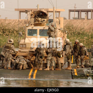 U.S. Army Soldiers from the 20th Engineer Brigade transport a vehicle across the Euphrates River Nov. 16, 2007, in support a combat operation near Baghdad, Iraq.  Spc. Luke Thornberry Stock Photo