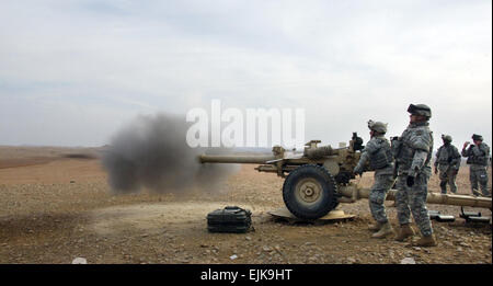 U.S. Army Soldiers from Bravo Battery, 3rd Battalion, 6th Field Artillery, 1st Brigade Combat Team, 10th Mountain Division fire a 105mm high explosive/time variable round from a howitzer during a day of shooting at the Warrior Range in Kirkuk, Iraq, Dec. 16, 2007. U.S. Army  Spc. Laura M. Buchta Stock Photo