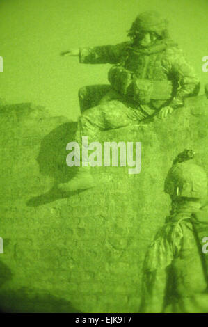 U.S. Army Soldiers assigned to 2nd Platoon, Charlie Company, 1st Battalion, 504th Parachute Infantry Regiment climb down a eight-foot wall during a patrol in Rusafa, Baghdad, Iraq, Feb. 19, 2008.  Staff Sgt. Jason T. Bailey Stock Photo