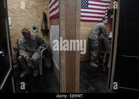 U.S. Army Spc. Paul Johnson waits for his smoking cessation appointment with U.S. Air Force Senior Airman Honey Brookover, a combat stress technician deployed from the 60th Medical Operations Squadron, on Forward Operating Base Kalsu, Iraq, March 6, 2008.  Master Sgt. Andy Dunaway Stock Photo