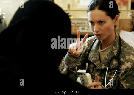 U.S. Army Capt. Jody Brown, a physician from Charlie Company, 225th Brigade Support Battalion, 2nd Stryker Combat Brigade Team, 25th Infantry Division, prescribes medication to a patient during a combined medical outreach program in Bata, Iraq, March 17, 2008.  Tech. Sgt. William Greer, U.S. Air Force. Stock Photo