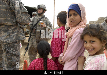Young girls wait in line to receive medical aid supplies from U.S. Army Soldiers assigned to Alpha Battery, 1st Battalion, 10th Field Artillery, 3rd Infantry Division during a medical operation in Sabah Nissan, Iraq, March 27, 2008.  Spc. Daniel Herrera Stock Photo