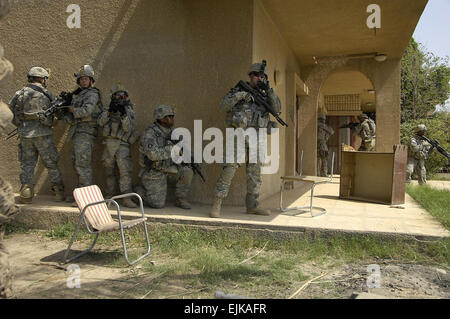 U.S. Army Soldiers from Bravo Company, 1st Battalion, 15th Infantry Regiment, 3rd Heavy Brigade Combat Team, 3rd Infantry Division conduct a cordon search and seizure of a house outside of Combat Outpost Carver, Iraq, March 30, 2008. This house was occupied by Al Qaeda operative Abu Ziyad and is being searched to confirm or deny it was used as a prison for hostages.  Spc. Daniel Herrera Stock Photo