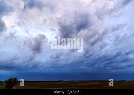 Dark dramatic rain clouds over countryside landscape.Summer in Hungary.
