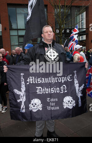 Manchester, UK 28th March, 2015. Far right demonstrators with flags & banners at the National Front and White Pride Demo in Piccadilly.  Arrests were made as Far Right 'White Pride' group gathered in Manchester to stage a demonstration when about 50 members of the group waved flags and marched through Piccadilly Gardens. Anti-fascist campaigners staged a counter-demonstration and police line separated the two sides. Greater Manchester Police said two arrests were made, one for a breach of the peace. The second was also held for a public order offence. Stock Photo