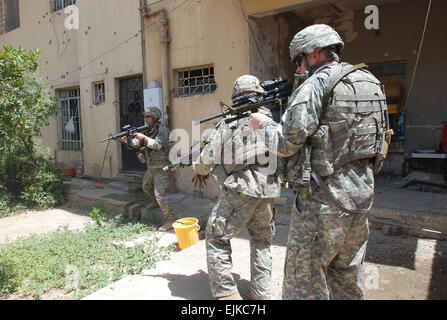 070616-A-5406P-006.JPG - from left Staff Sgt. Michael Mullahy, of Batavia, Ill., Pfc. Garren Hulett, of Dover, N.H., and 1st Lt. Travis Atwood, of Abilene Texas, clear a courtyard a group of insurgents had retreated into during a firefight in Baghdad's Adhamiyah neighborhood June 16 that ended with one insurgent dead and three captured. All three Soldiers are with Charlie Company, 1st Battalion, 26th Infantry Regiment, based in Schweinfurt, Germany.  Sgt. Mike Pryor, 2nd BCT, 82nd Airborne Division Public Affairs Stock Photo