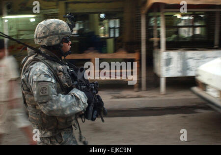 U.S. Army Soldiers with 2nd Platoon, Bravo Battery, 2nd Battalion, 319th Airborne Field Artillery Regiment conduct a dismounted patrol in Baghdad, Iraq, June 12, 2007.  Sgt. Jeffrey Alexander Stock Photo