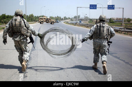 U.S. Army Paratroopers with 1st Platoon, Alpha Battery, 2nd Battalion, 319th Airborne Field Artillery Regiment, 82nd Airborne Division set up a traffic control point in Adhamiya, Iraq, alongside Iraq security forces June 19, 2007.  Sgt. Jeffrey Alexander Stock Photo