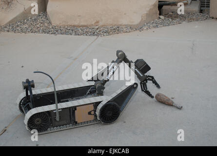 An iRobot PackBot picks up a demonstration object at the Joint Robotics Repair Detachment at Victory Base Complex, Baghdad, Iraq. The robots can be operated by a commercial off-the shelf controller or a heads-up display. Stock Photo