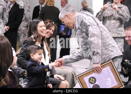 Chief of Staff of the Army Gen. George W. Casey Jr. greets 4-year-old Michael Carreker, Jan. 22 at the Asymmetric Warfare Group’s Resource Operations Center on Fort Meade, Md. Michael was on hand to watch his father, Master Sgt. Michael Carreker, receive the Combat Action Badge. Stock Photo