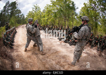 U.S. Army paratroopers with the 82nd Airborne Division’s 1st Brigade Combat Team demonstrate their enemy prisoner-of-war handling techniques to Indian Army soldiers of the 99th Mountain Brigade during partnered field training May 8, 2013, at Fort Bragg, N.C.  As part of the annual Yudh Abhyas training between the Indian Army and United States Army Pacific, participating soldiers become better able to respond to a wide variety of contingencies.   Sgt. Michael J. MacLeod Stock Photo
