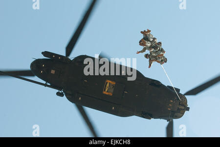 Six U.S. Army Soldiers assigned to 4th Battalion, 118th Infantry Regiment, South Carolina Army National Guard, fly through the air while tethered from an MH47G Chinook provided by the 160th Special Operations Aviation Regiment Airborne during Special Insertion Exfiltration System training at McCrady Training Center, Eastover, S.C., May 17, 2014. The 160th SOAR A supported a joint mission with 7th Special Forces Group Airborne training over 100 Soldiers assigned to 4th Battalion, 118th Infantry Regiment, South Carolina Army National Guard.   U.S. Army National Guard photo by Sgt. 1st Class Kimb Stock Photo