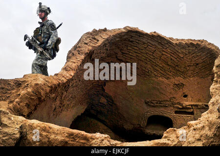 U.S. Army Sgt. David Smitt maintains over watch during an air assault patrol with U.S. soldiers and British gunners in Afghanistan's Kandahar province on Feb. 10, 2011.  Smitt is assigned to 101st Combat Aviation Brigade and the gunners are assigned to the Royal Air Force Regiment's 15th Squadron.   Sadie Bleistein, U.S. Army.   Read about coalition forces detaining Afghan militia here -- /-news/2011/02/23/52246-coalition-forces-deta...  /-news/2011/02/23/52246-coalition-forces-detain-afghan-militants/ Stock Photo