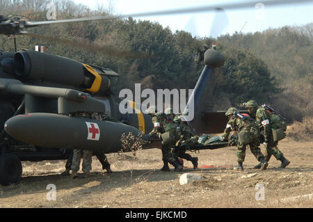 Republic of Korea ROK combat medics with Medical Battalion, 1st ROK Division load a simulated wounded soldier into a U.S. Army UH-60 Black Hawk helicopter from 3rd Battalion, 2nd General Service Aviation Battalion, 2nd Infantry Division during a joint casualty evacuation exercise in Uijongbu, South Korea, March 5, 2008. The exercise is part of Exercise Key Resolve/Foal Eagle 2008, an annual combined joint exercise involving forces from both the U.S. and the ROK.  Mass Communication Specialist 1st Class Lou Rosales, U.S. Navy. Released Stock Photo