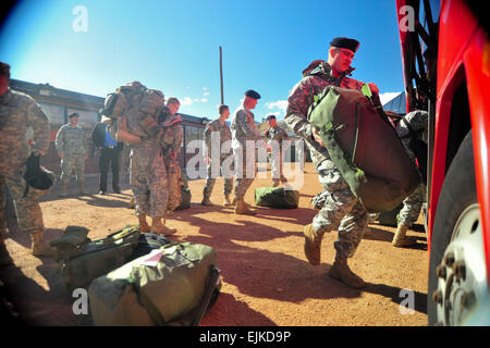 Colorado Army National Guard Headquarters and Headquarters Battery Soldiers load their gear onto buses at their Colorado Springs Armory Feb. 9, 2009. The troops will conduct required training at Fort Carson, Colorado Springs, Colo., prior to leaving for Fort Hood, Texas, in mid-April.  Staff Sgt. Liesl Marelli Released Stock Photo