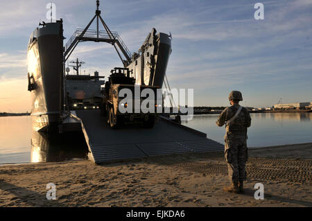 Waterborne Soldiers of the 10th Transportation Battalion spend the morning of Feb. 7 loading vehicles on board the Logistic Support Vessel-4, the Lt. Gen. William B. Bunker, at 3rd Port as part of a battalion Field Training Exercise conducted at Fort Eustis and Joint Expeditionary Base Little Creek where upon completion of its sail of the James River the LSV-4 drops ramp at the mud flats of Little Creek so Army transporters assigned to the 359th Inland Cargo Transfer Company may begin the transfer of vehicles to the battalion's collection point.  Sgt. 1st Class Kelly Jo Bridgwater, 7th Sustain Stock Photo