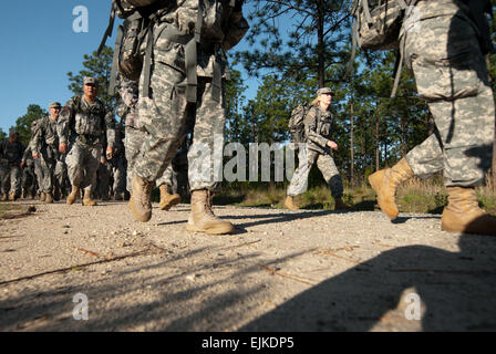 Non-commissioned officers from the U.S. Army Reserve Command headquarters conduct a ruck march during an NCO Development Program event at Smith Lake Recreation Area, Fort Bragg, N.C., May 11, 2012. The ruck march, covering approximately five miles, was the latest NCODP event conducted monthly by USARC NCOs from the different staff sections in the headquarters. Stock Photo