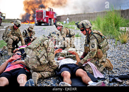 Soldiers from 2nd platoon, Whiskey Company, 2nd Battalion, 506th Infantry Regiment, attached to the 4th Brigade Special Troops Battalion, attend to simulated casualties at the casualty collection point during a mass casualty exercise on Forward Operating Base Salerno, Afghanistan, Aug. 6, 2013.  Maj. Kamil Sztalkoper, 4th Brigade Public Affairs office Stock Photo