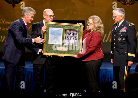 Secretary of the Army John McHugh, presents a plaque to Phil Miller, father of Medal of Honor recipient US Army Staff Sgt. Robert J. Miller and mother Maureen Miller, as Chief of Staff of the Army Gen. George W. Casey, Jr. looks on during a ceremony at the Pentagon, Oct. 7, 2010.  Miller was posthumously awarded the nation's highest honor for his heroic actions in Afghanistan on January 25, 2008, after displaying immeasurable courage and uncommon valor eventually sacrificing his own life to save the lives of his teammates and 15 Afghanistan National Army soldiers.  Defense Department photo by  Stock Photo