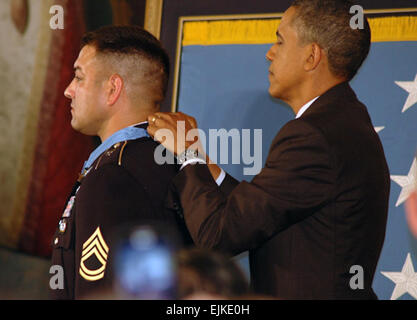 Sgt. 1st Class Leroy A. Petry receives the Medal of Honor from President Barack Obama at the White House, July 12. Petry received the Medal of Honor for his actions during a mission on May 26, 2008, serving as a squad leader with Delta Company, 2nd Battalion, 75th Ranger Regiment was conducting a mission in rural eastern Afghanistan with his unit to capture a high-value insurgent target. Early in the mission, the squad came under heavy enemy fire and Petry was shot in both legs. Despite his wounds, the Ranger gallantly continued fighting alongside his brothers in arms. When an enemy hand grena Stock Photo