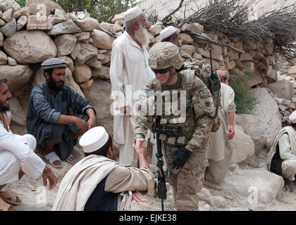 First Lt. Daniel Grachanin of Edmond Okla., acting platoon leader in Company D, 1st Battalion, 179th Infantry Regiment, 45th Infantry Brigade Combat Team greets village elders as his platoon and Afghan National Security Forces walk through a village in southern Laghman province. Members of Company C and their ANSF conducted a combined operation to help provide security.    by Spc. Leslie Goble. Stock Photo