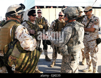 First Lt. Carlos Trujillo, right, a platoon leader in Battery B, 1st Battalion, 7th Field Artillery Regiment, 2nd Advise and Assist Brigade, 1st Infantry Division, United States Division- Center and an El Paso, Texas native, greets Italian Maj. Gen. Armentani, left, the Deputy Commanding General for the NATO Training Mission in Iraq, on Sept. 19, 2011 at the International Zone, Iraq. Trujillo briefed Armentani and his men prior to their movement to a construction site.  Capt. Christopher Miles, 1-7 FA, 1st Inf. Div., USD-C Stock Photo