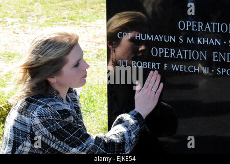 Becky Welch, widow of 1st Lt. Robert F. Welch, takes a moment to remember at the Memorial Dedication and Fallen Hero Ceremony, March 9. The day’s events culminated in the dedication of a memorial for all the 3rd Brigade Combat Team, 1st Infantry Division Soldiers who have died since 2001 in the Global War on Terror. 1st Lt. Welch died last year from wounds suffered in a rocket attack at Forward Operating Base Salerno, Afghanistan.  Staff Sgt. John Zumer, 3/1 BCT Public Affairs Stock Photo