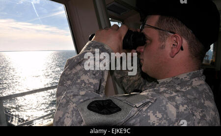 Chief Warrant Officer Ned Walsh, executive officer, Logistic Support Vessel-4, the Lt. Gen. William B. Bunker, 1099th Transportation Detachment, 10th Trans. Battalion, 7th Sustainment Brigade, Fort Eustis, Va. monitors the waters of the James River from the vessel's bridge as it sails toward Joint Expeditionary Base Little Creek during the battalion's Field Training Exercise Feb. 7.  Sgt. 1st Class Kelly Jo Bridgwater, 7th Sustainment Brigade Public Affairs Stock Photo