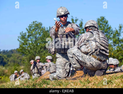 U.S. Army Pfc. Joseph Guzman, 1st Battalion, 181st Infantry Regiment, prepares to drop a 60mm mortar to launch at fixed targets at Camp Atterbury Joint Maneuver Training Center, Indiana, on August 31, 2010.  The Massachusetts National Guard unit is training to provide security to roughly a dozen provincial reconstruction teams across Afghanistan.   John Crosby, U.S. Army. Stock Photo