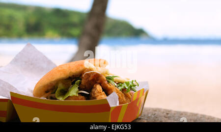 Fried shark and bake fast food outdoors by the beach at Maracas Bay in Trinidad and Tobago authentic traditional local Caribbean Stock Photo