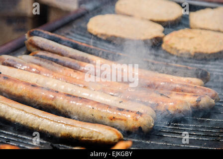 Sausages and hamburgers on a barbecue grill Stock Photo