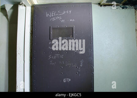Graffiti on the inside of a prison holding cell Stock Photo