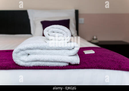 Close-up clean towels and soap in hotel room Stock Photo