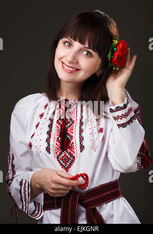 charming woman in an embroidered shirt with flower in hair Stock Photo