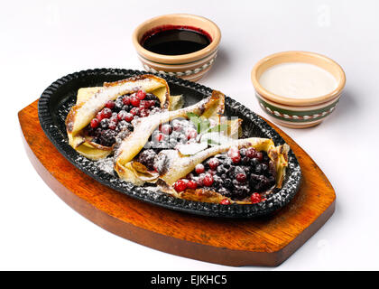 pancakes with sour cream ,berries and cherry jam Stock Photo