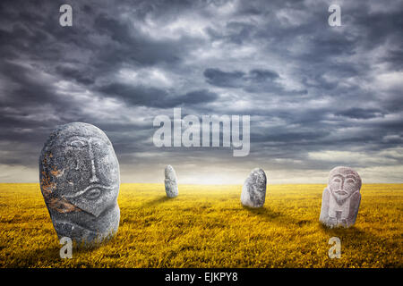 Ancient balbal statues on the field at overcast sky in central Asia Stock Photo