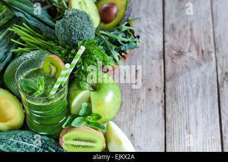 Green detox smoothie with raw vegetables and fruits. Copyspace background. Stock Photo
