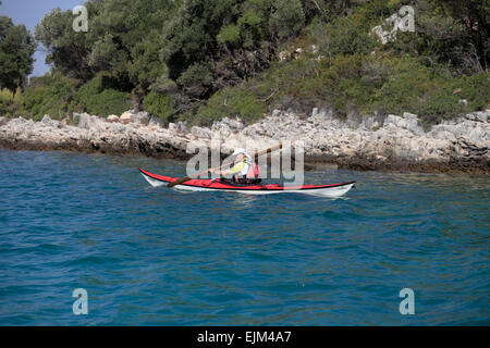 Mature kayaker canoeing Man paddling sea kayak off Badija Island near Korcula Croatia Stock Photo