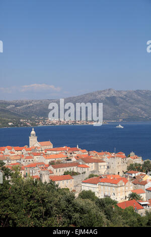 Korcula old town Looking down on red tiled roofs of fortified medieval town backed by Adriatic sea and Dalmatian coast. Croatia Stock Photo