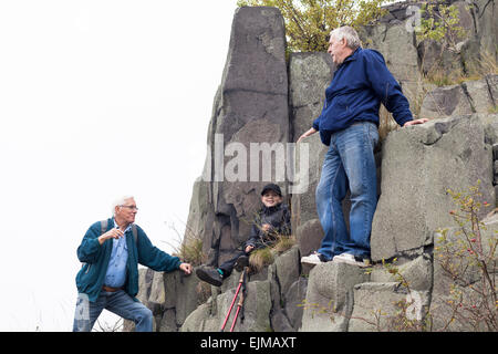 Senior men with child boy trekking on rocky terrain. Stock Photo