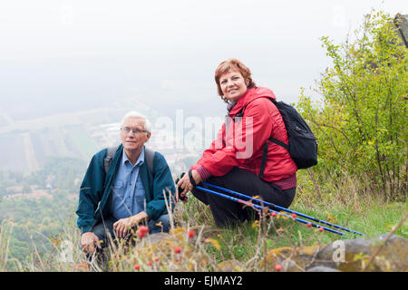 Senior couple on hiking trip resting in the nature. Stock Photo