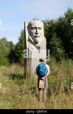 Tourist looking at an old bust of Lenin at the Estonian History Museum Stock Photo