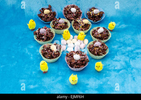 Collection of mini chocolate Easter eggs, cornflake cakes and baby chicks Stock Photo