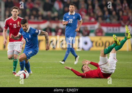 Budapest, Hungary. 29th Mar, 2015. Panagiotis Kone (2nd L) of Greece fights for the ball with Zoltan Gera (1st L) and Daniel Tozser (1st R) of Hungary during their UEFA Euro 2016 Group F qualifying match at the Groupama Arena stadium in Budapest, Hungary on March 29, 2015. The match ended with 0-0 draw. Credit:  Attila Volgyi/Xinhua/Alamy Live News Stock Photo